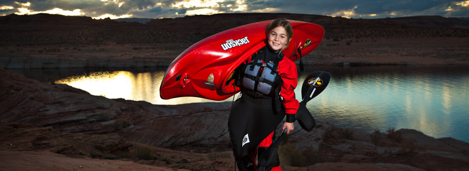 Abby Holcombe caries her boat on the shore of Lake Powell, AZ